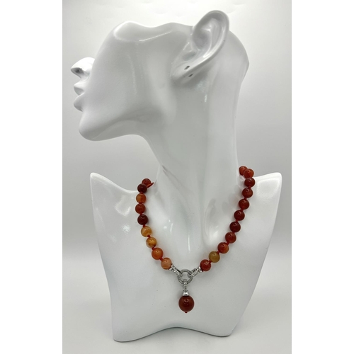 1658 - A Red Striped Agate Bead Necklace with Decorative Pendant Drop. 10mm beads. 44cm necklace length. 3.... 