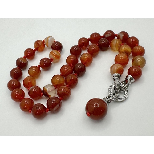 1658 - A Red Striped Agate Bead Necklace with Decorative Pendant Drop. 10mm beads. 44cm necklace length. 3.... 