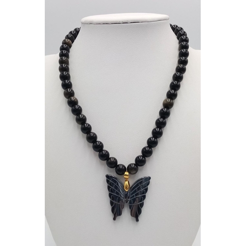 1659 - A Black Onyx Necklace with Hematite Butterfly Pendant. 40cm necklace.