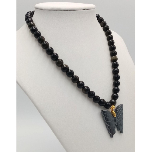 1659 - A Black Onyx Necklace with Hematite Butterfly Pendant. 40cm necklace.