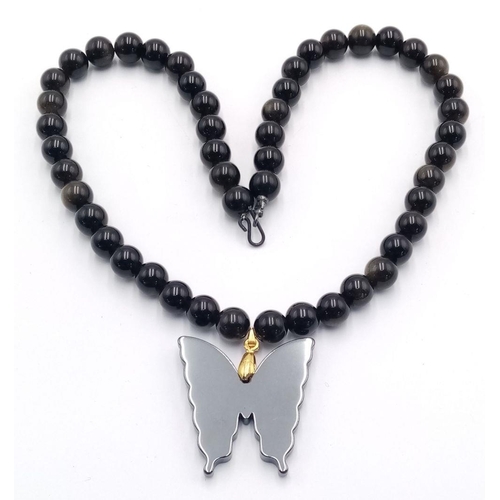 1659 - A Black Onyx Necklace with Hematite Butterfly Pendant. 40cm necklace.