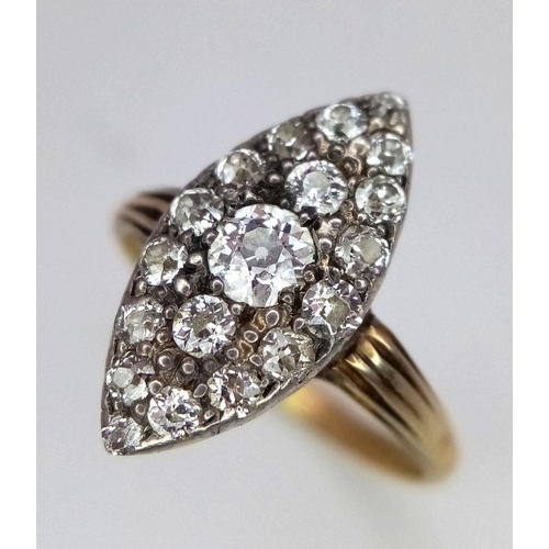 207 - A Vintage 18K Yellow Gold (tested) Marquise Shape Diamond Ring. 19 different sized round cut diamond... 