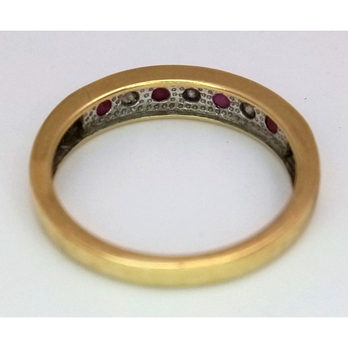 221 - An 18K Yellow Gold Ruby and Diamond Seven Stone Ring. 
Size N. 3.19g. Ref: 17877