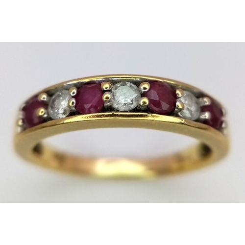 221 - An 18K Yellow Gold Ruby and Diamond Seven Stone Ring. 
Size N. 3.19g. Ref: 17877