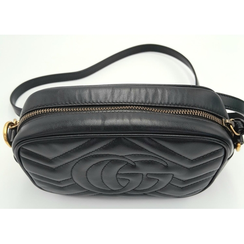 125 - A Gucci Black Marmont Crossbody Bag. Matelassé leather exterior, with gold-toned hardware, chain and... 