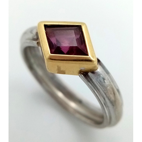 200 - An 18K White and Yellow Gold Ruby Ring. A rhombus shaped cut ruby. Size O 1/2. 5.3g total weight. 1c... 