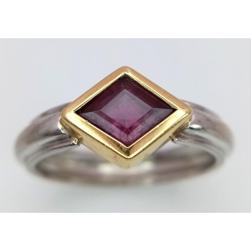 200 - An 18K White and Yellow Gold Ruby Ring. A rhombus shaped cut ruby. Size O 1/2. 5.3g total weight. 1c... 