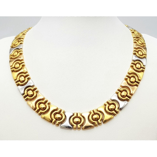 25 - A Gorgeous 18K Yellow and White Gold Necklace. Geometric, articulated design. 14mm width. 42cm neckl... 