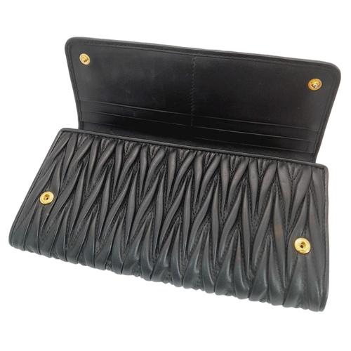 263 - A Miu Miu Black Continental Purse/Wallet. Matelassé leather exterior with double press stud closure.... 