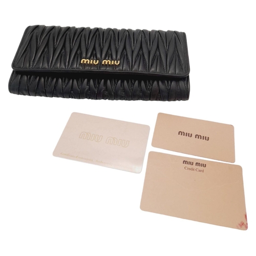 263 - A Miu Miu Black Continental Purse/Wallet. Matelassé leather exterior with double press stud closure.... 