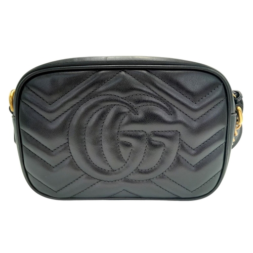 125 - A Gucci Black Marmont Crossbody Bag. Matelassé leather exterior, with gold-toned hardware, chain and... 