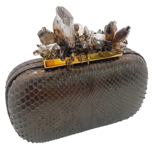 179 - A Madiso Brown Clutch Bag. Python skin exterior with stone embellish clasp fastening closure. Silver... 