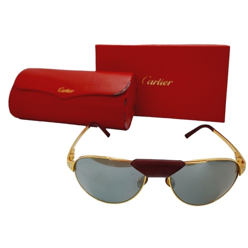 193 - A Pair of Designer Cartier Santos Sunglasses. Gilded frames with the classic screw design. Comes wit... 