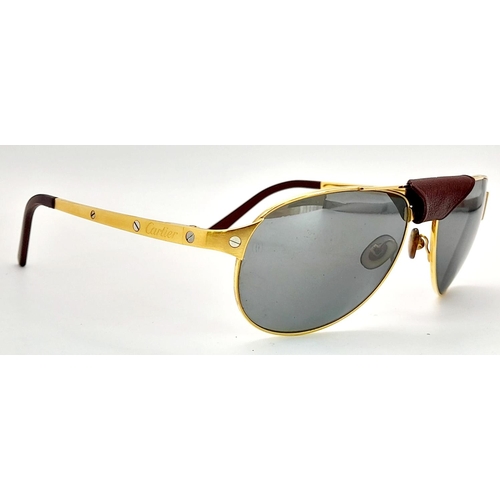 193 - A Pair of Designer Cartier Santos Sunglasses. Gilded frames with the classic screw design. Comes wit... 