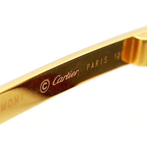 193 - A Pair of Designer Cartier Santos Sunglasses. Gilded frames with the classic screw design. Comes wit... 