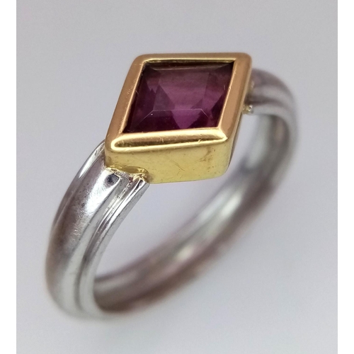 200 - An 18K White and Yellow Gold Ruby Ring. A rhombus shaped cut ruby. Size O 1/2. 5.3g total weight. 1c... 