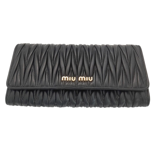 263 - A Miu Miu Black Continental Purse/Wallet. Matelassé leather exterior with double press stud closure.... 