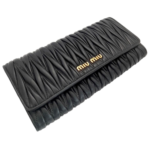 263 - A Miu Miu Black Continental Purse/Wallet. Matelassé leather exterior with double press stud closure.... 