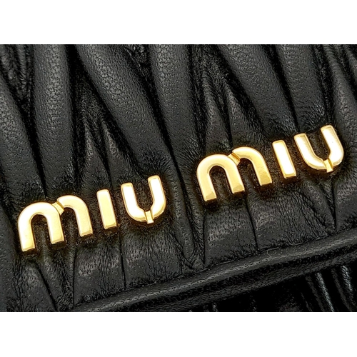 263 - A Miu Miu Black Continental Purse/Wallet. Matelassé leather exterior with double press stud closure.... 