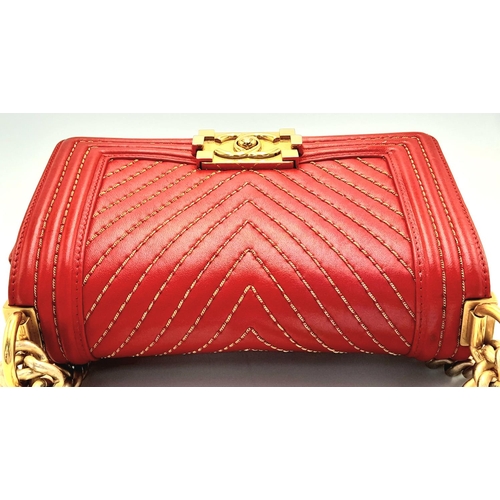 34 - A Chanel Red Boy Bag. Quilted leather exterior with gold-tone hardware, leather and chain strap and ... 