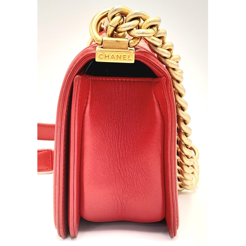 34 - A Chanel Red Boy Bag. Quilted leather exterior with gold-tone hardware, leather and chain strap and ... 