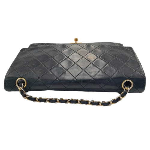 60 - A Classic Vintage Chanel Mid-Size Flap Shoulder Bag. Quilted leather exterior with gold-tone hardwar... 