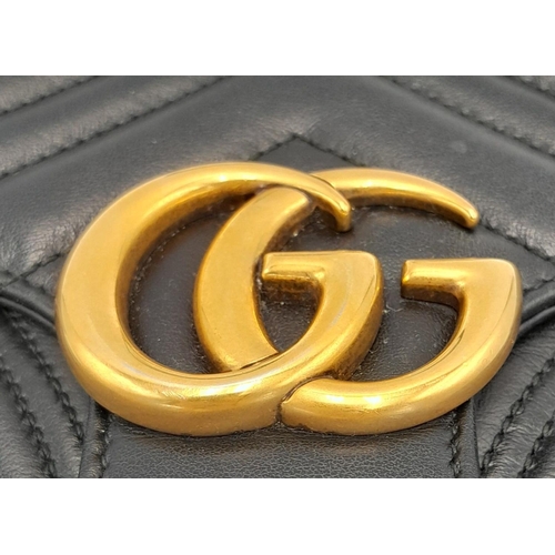 88 - A Gucci Black Marmont Flap Bag. Matelassé leather exterior with gold-toned hardware, chain and leath... 
