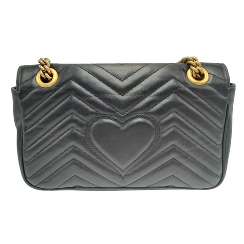 88 - A Gucci Black Marmont Flap Bag. Matelassé leather exterior with gold-toned hardware, chain and leath... 