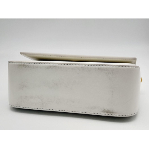 17 - A Tom Ford White Bianca Bag. Leather exterior with gold-toned hardware, handle and magnetic closure.... 