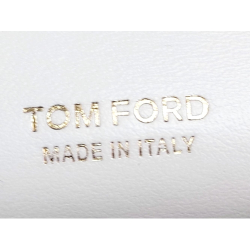 17 - A Tom Ford White Bianca Bag. Leather exterior with gold-toned hardware, handle and magnetic closure.... 