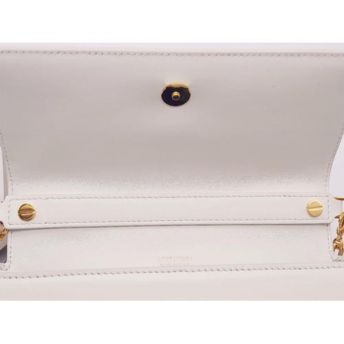 17 - A Tom Ford White Bianca Bag. Leather exterior with gold-toned hardware, handle and magnetic closure.... 