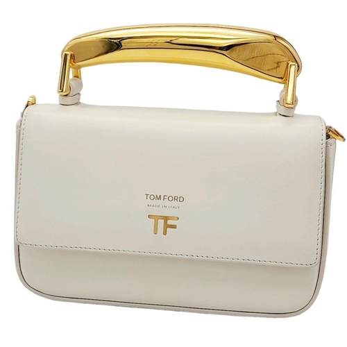 17 - A Tom Ford White Bianca Bag. Leather exterior with gold-toned hardware, handle and magnetic closure.... 