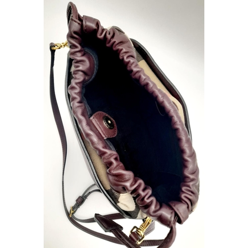 186 - A Burberry Burgundy Bridle Horse Cross Body Bag. Leather and the iconic Burberry nova check textile ... 
