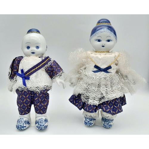 276 - A pair of Chinese Blue & White porcelain dolls – a boy and a girl – in traditional clothing, export ... 