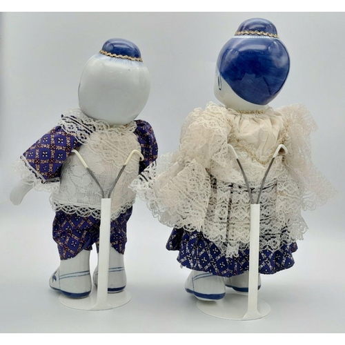 276 - A pair of Chinese Blue & White porcelain dolls – a boy and a girl – in traditional clothing, export ... 