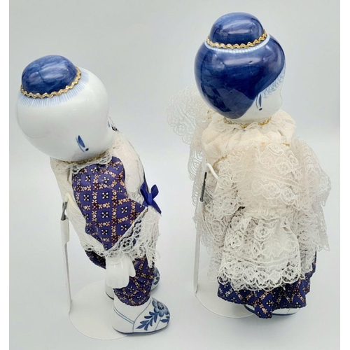 276 - A pair of Chinese Blue & White porcelain dolls – a boy and a girl – in traditional clothing, export ... 