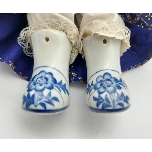 276 - A pair of Chinese Blue & White porcelain dolls – a boy and a girl – in traditional clothing, export ... 