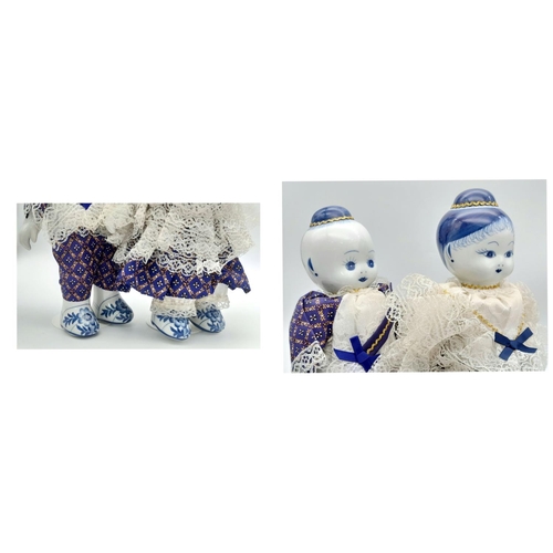 276 - A pair of Chinese Blue & White porcelain dolls – a boy and a girl – in traditional clothing, export ... 