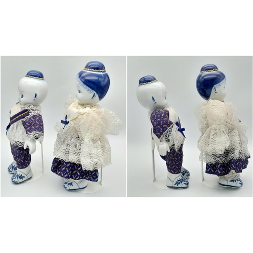 276 - A pair of Chinese Blue & White porcelain dolls – a boy and a girl – in traditional clothing, export ... 