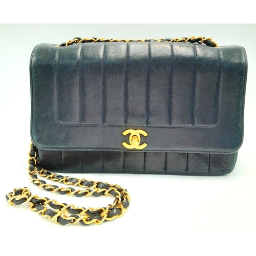41 - A Classic Vintage Diana Shoulder Bag. Vertical quilted black leather exterior. Gold tone hardware. G... 
