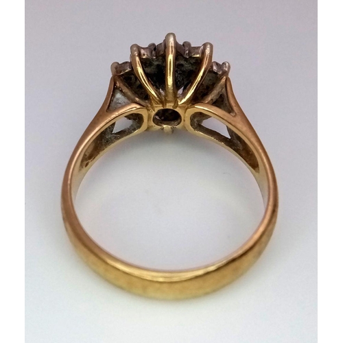 431 - A 9K GOLD RING WITH A SAPPHIRE SURROUNDED BY DIAMONDS .     4.1gms   size N