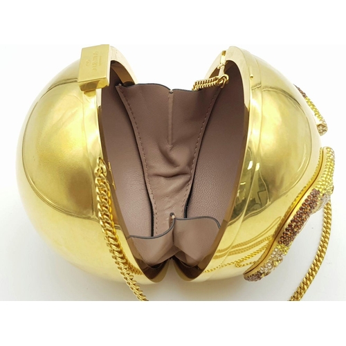 67 - A Valentino Gold Orb Clutch Bag. Metal exterior with a stone embellished V logo and clasp fastening ... 