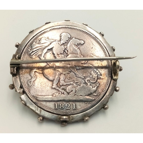 119 - 1821 GEORGE IV SILVER CROWN in Very Fine condition. Mounted in a SILVER cartwheel BROOCH/PENDANT.