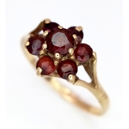 122 - A VERY PRETTY 9K GOLD RING WITH GARNET CLUSTER .    1.9gms    size N