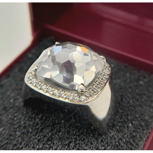 385 - A PRISM CUT QUARTZ CABOCHON set in a SILVER RING with clear Gemstone surround. Inside band showing 9... 