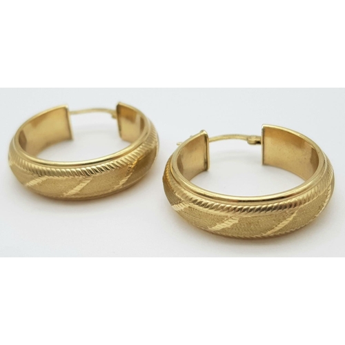 396 - A PAIR OF SOLID CHUNKY 9K GOLD EARRINGS WITH GEOMETRICAL PATTERN .   3.8gms