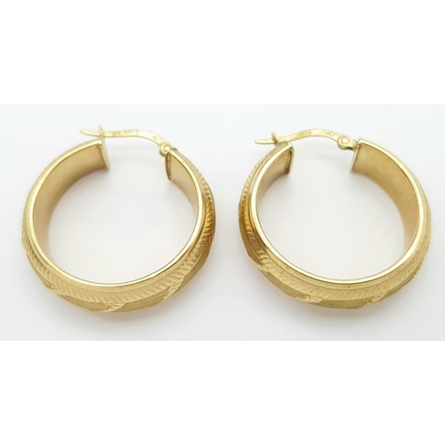 396 - A PAIR OF SOLID CHUNKY 9K GOLD EARRINGS WITH GEOMETRICAL PATTERN .   3.8gms