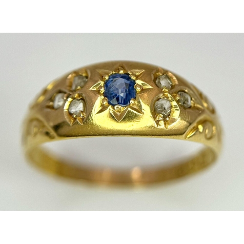 403 - AN ANTIQUE 18K GOLD RING SET WITH CENTRAL SAPPHIRE AND SIX SMALL DIAMONDS  .    2.0gms   size P/Q