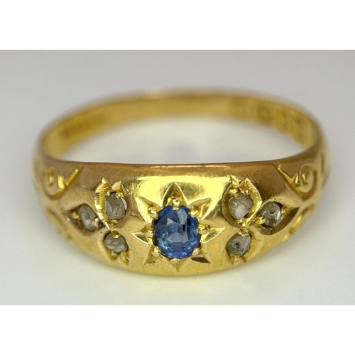 403 - AN ANTIQUE 18K GOLD RING SET WITH CENTRAL SAPPHIRE AND SIX SMALL DIAMONDS  .    2.0gms   size P/Q