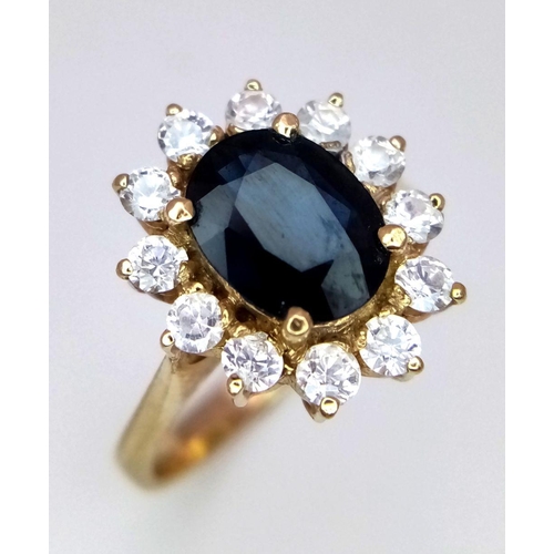 64 - A 14K Yellow Gold Sapphire and Diamond Ring. A beautiful 2ct oval sapphire with a brilliant round cu... 